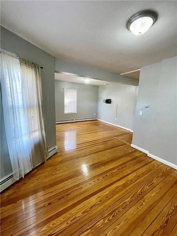 86 Edgemere Ave, Providence, RI 02909 - unfurnished room featuring baseboard heating, wood finished floors, and baseboards