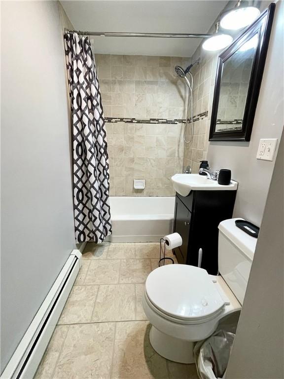 86 Edgemere Ave, Providence, RI 02909 - bathroom featuring a baseboard heating unit, toilet, shower / bath combination with curtain, and vanity