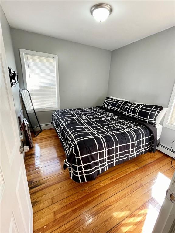 86 Edgemere Ave, Providence, RI 02909 - bedroom with hardwood / wood-style flooring, multiple windows, and baseboard heating