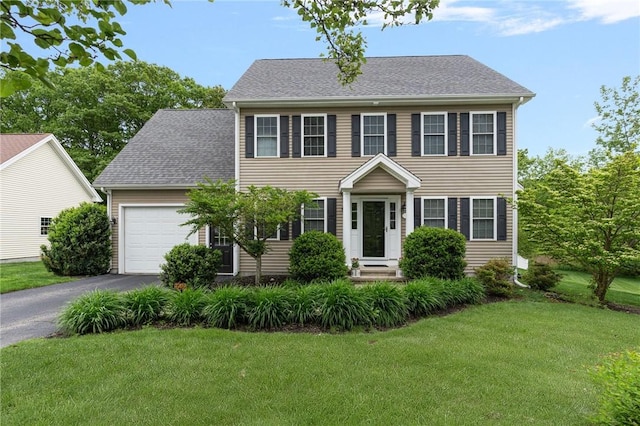 3 Berm Dr, Cumberland, RI 02864 - colonial house featuring a garage, asphalt driveway, a front yard, entry steps, and roof with shingles