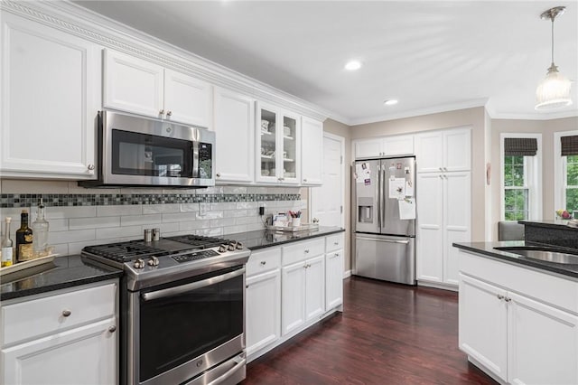 3 Berm Dr, Cumberland, RI 02864 - kitchen with stainless steel appliances, crown molding, a sink, tasteful backsplash, and white cabinetry