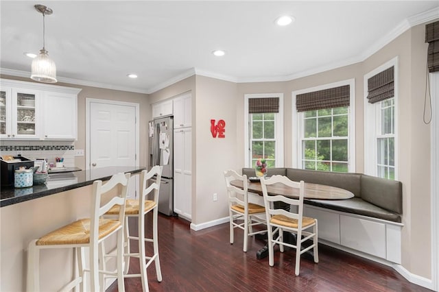3 Berm Dr, Cumberland, RI 02864 - dining space with dark wood-type flooring, baseboards, recessed lighting, ornamental molding, and breakfast area