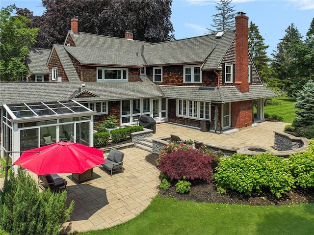 211 Rumstick Rd, Barrington, RI 02806 - rear view of house featuring a chimney, a patio, and a sunroom