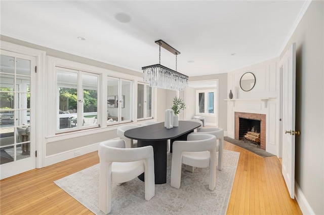 211 Rumstick Rd, Barrington, RI 02806 - dining area with light wood-style flooring and a fireplace