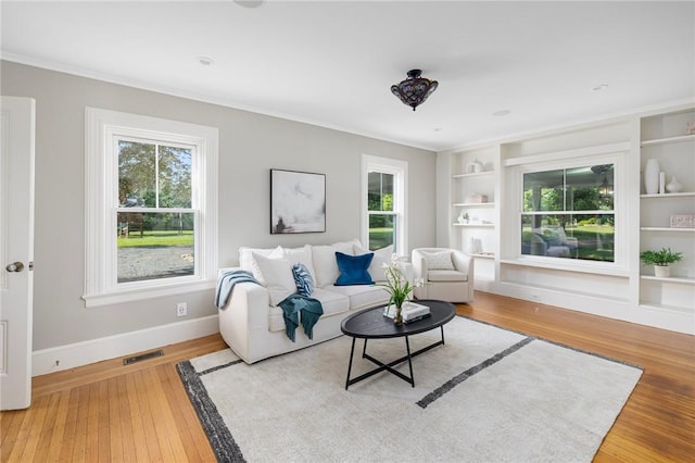211 Rumstick Rd, Barrington, RI 02806 - living area featuring built in features, wood finished floors, and crown molding
