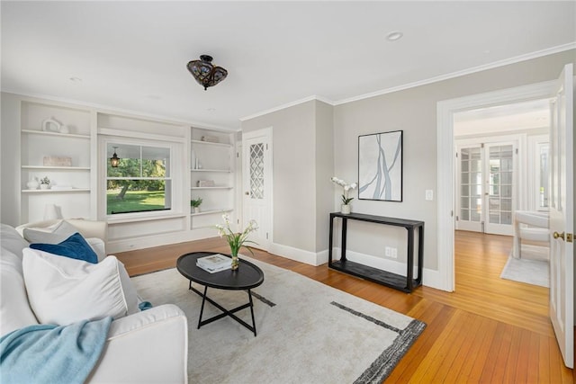 211 Rumstick Rd, Barrington, RI 02806 - living area with light wood-style flooring, ornamental molding, and built in shelves