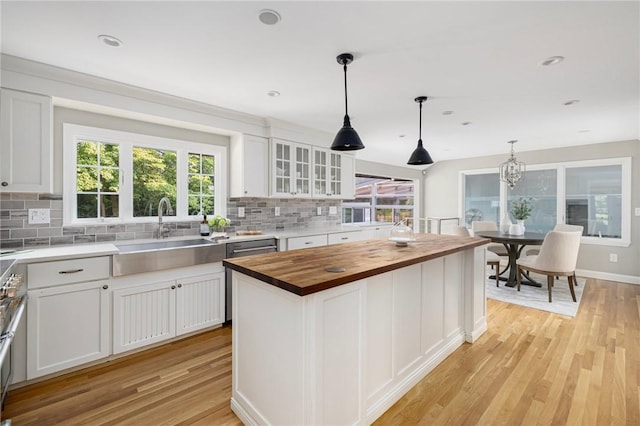 211 Rumstick Rd, Barrington, RI 02806 - kitchen with wooden counters, backsplash, light wood-style floors, white cabinetry, and recessed lighting