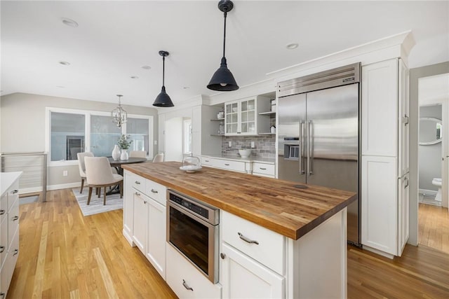 211 Rumstick Rd, Barrington, RI 02806 - kitchen with wood counters, built in fridge, open shelves, white cabinets, and recessed lighting