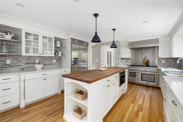 211 Rumstick Rd, Barrington, RI 02806 - kitchen with open shelves, wood counters, high end appliances, wall chimney exhaust hood, and decorative backsplash