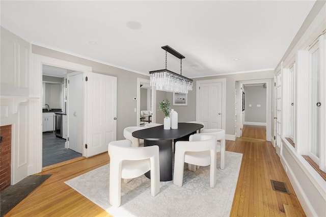 211 Rumstick Rd, Barrington, RI 02806 - dining space featuring light wood-style flooring and ornamental molding
