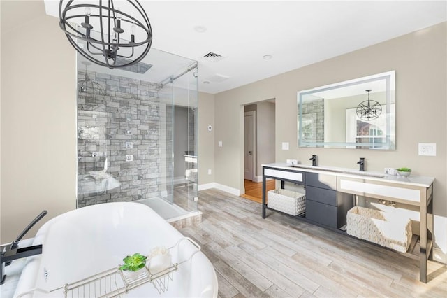 211 Rumstick Rd, Barrington, RI 02806 - bathroom featuring a chandelier, a soaking tub, vanity, wood finished floors, and a shower stall
