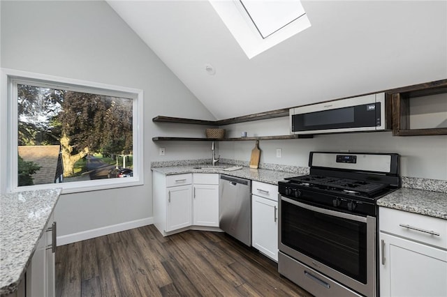 211 Rumstick Rd, Barrington, RI 02806 - kitchen with stainless steel appliances, open shelves, a skylight, vaulted ceiling, and white cabinetry