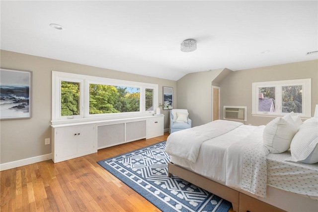 211 Rumstick Rd, Barrington, RI 02806 - bedroom with radiator, light wood-style floors, vaulted ceiling, and a wall unit AC