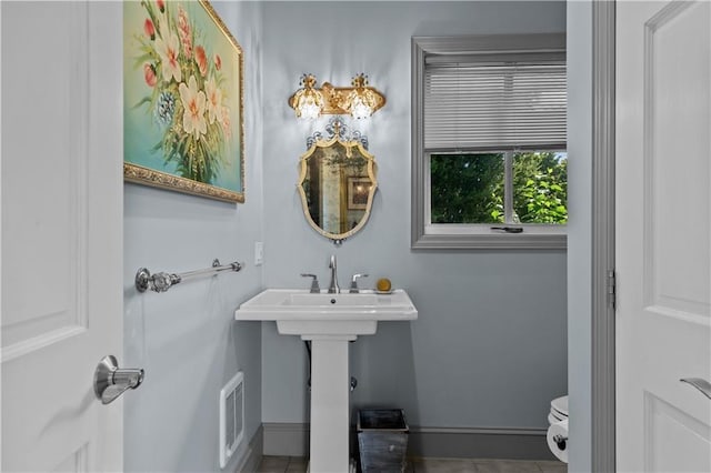 33 Courageous Cir, Bristol, RI 02809 - half bath with baseboards, tile patterned floors, and toilet