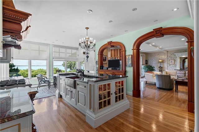 33 Courageous Cir, Bristol, RI 02809 - kitchen featuring a sink, arched walkways, light wood-style floors, open floor plan, and recessed lighting