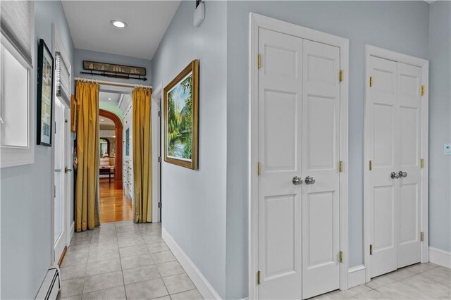 33 Courageous Cir, Bristol, RI 02809 - corridor with a baseboard heating unit, baseboards, light tile patterned floors, and recessed lighting