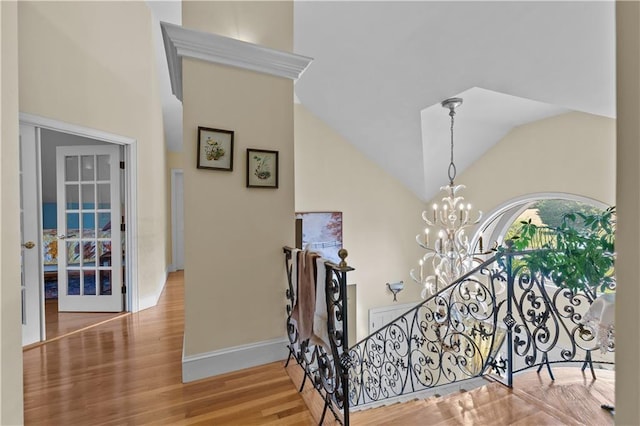 33 Courageous Cir, Bristol, RI 02809 - stairway with a chandelier, wood finished floors, high vaulted ceiling, and baseboards
