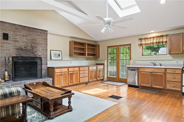 75 Circuit Dr, Narragansett, RI 02882 - kitchen featuring dishwasher, lofted ceiling, light wood-style flooring, a skylight, and a brick fireplace