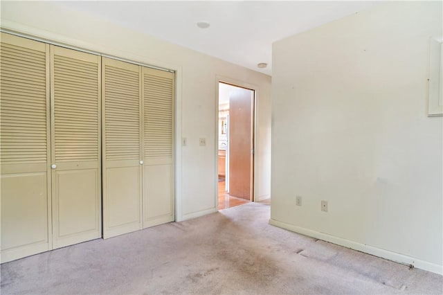 75 Circuit Dr, Narragansett, RI 02882 - unfurnished bedroom with light carpet, a closet, and baseboards