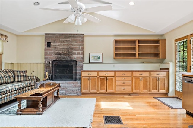 75 Circuit Dr, Narragansett, RI 02882 - living area featuring vaulted ceiling, a fireplace, light wood finished floors, a ceiling fan, and a wainscoted wall