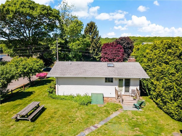 75 Circuit Dr, Narragansett, RI 02882 - view of front of property with a front yard, roof with shingles, a deck, and a chimney