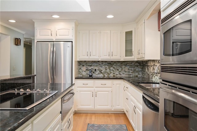70 High Ridge Dr, Cumberland, RI 02864 - kitchen with stainless steel appliances, a warming drawer, light wood finished floors, dark stone countertops, and white cabinetry