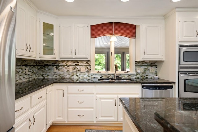 70 High Ridge Dr, Cumberland, RI 02864 - kitchen featuring a sink, appliances with stainless steel finishes, white cabinetry, dark stone countertops, and backsplash