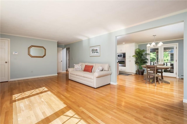 70 High Ridge Dr, Cumberland, RI 02864 - living area featuring light wood-style floors, ornamental molding, baseboards, and a chandelier