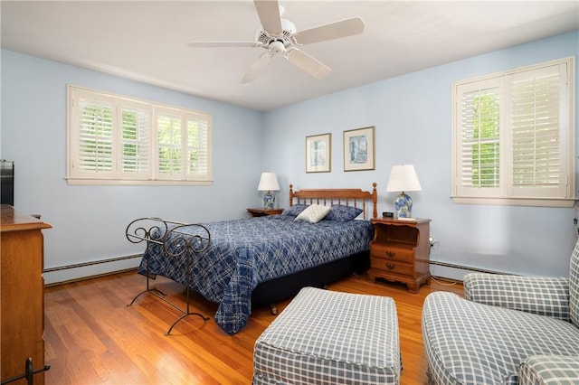 70 High Ridge Dr, Cumberland, RI 02864 - bedroom featuring a baseboard heating unit, wood finished floors, and ceiling fan