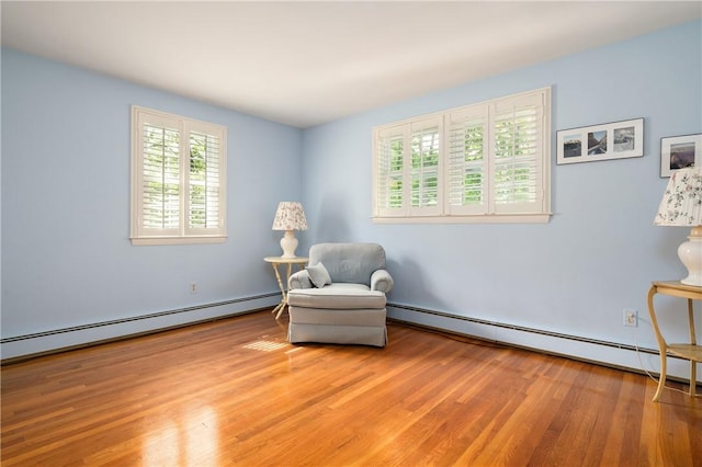 70 High Ridge Dr, Cumberland, RI 02864 - living area with a baseboard heating unit and light wood-style flooring