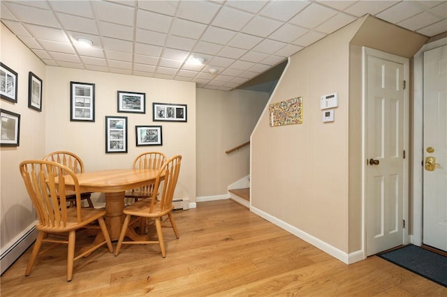 70 High Ridge Dr, Cumberland, RI 02864 - dining space with baseboard heating, stairs, light wood-type flooring, and baseboards