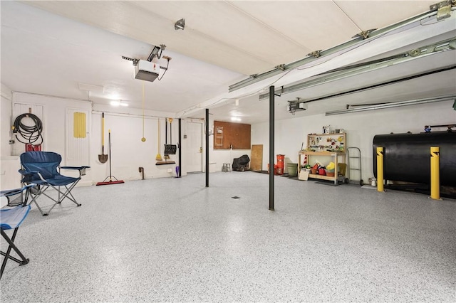 70 High Ridge Dr, Cumberland, RI 02864 - garage featuring oil tank and a garage door opener