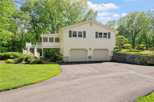 70 High Ridge Dr, Cumberland, RI 02864 - view of front of home featuring stairway, asphalt driveway, a front yard, a garage, and a deck