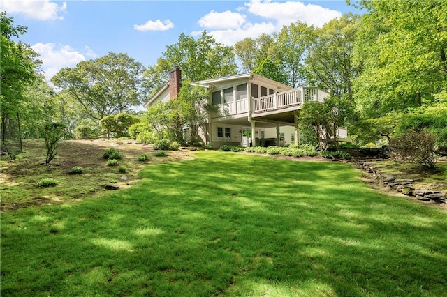 70 High Ridge Dr, Cumberland, RI 02864 - rear view of house featuring a chimney, a wooden deck, a lawn, and a sunroom