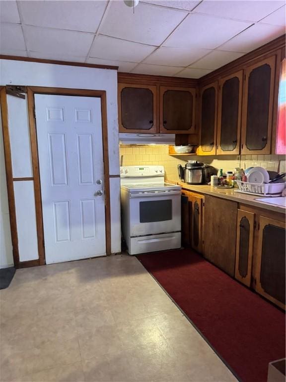 143 Mineral Spring Ave, Pawtucket, RI 02860 - kitchen featuring electric stove, under cabinet range hood, light countertops, dark floors, and a drop ceiling