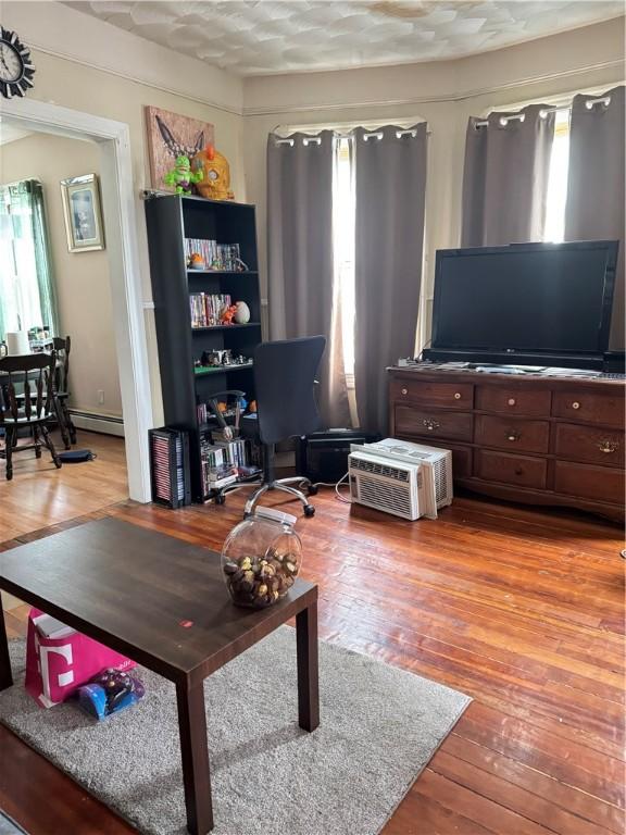 143 Mineral Spring Ave, Pawtucket, RI 02860 - living room with hardwood / wood-style floors and a baseboard heating unit