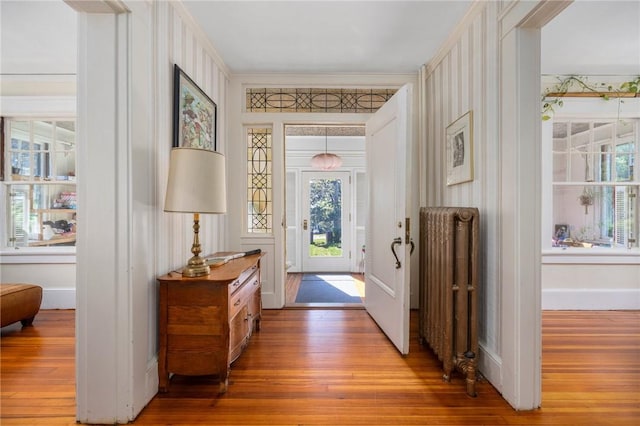 130 Highland Rd, Tiverton, RI 02878 - foyer with radiator heating unit, hardwood / wood-style floors, and ornamental molding
