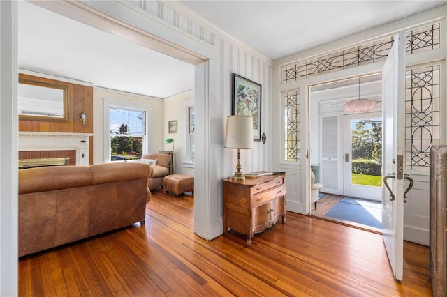 130 Highland Rd, Tiverton, RI 02878 - entryway featuring hardwood / wood-style floors, crown molding, and a brick fireplace