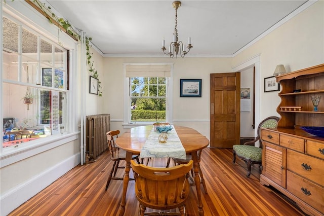 130 Highland Rd, Tiverton, RI 02878 - dining space with radiator, wood finished floors, a chandelier, and crown molding