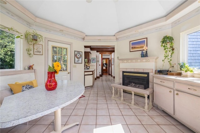 130 Highland Rd, Tiverton, RI 02878 - kitchen with a glass covered fireplace, light tile patterned floors, light countertops, and crown molding