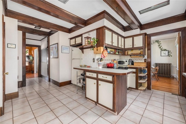 130 Highland Rd, Tiverton, RI 02878 - kitchen featuring radiator heating unit, open shelves, a peninsula, light tile patterned floors, and beam ceiling