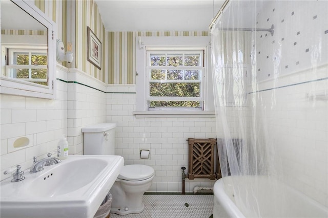130 Highland Rd, Tiverton, RI 02878 - full bath with wallpapered walls, tile walls, plenty of natural light, tile patterned flooring, and shower / bath combo