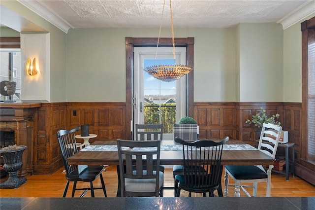 423 Hope St Unit C, Bristol, RI 02809 - dining area with wainscoting, wood finished floors, wood walls, and ornamental molding