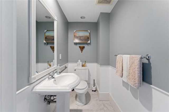 423 Hope St Unit C, Bristol, RI 02809 - bathroom with toilet, marble finish floors, a sink, and baseboards