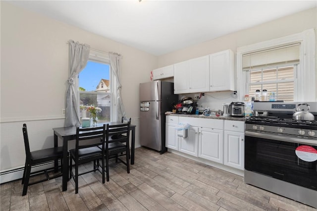 9 Sackett St, Providence, RI 02907 - kitchen featuring appliances with stainless steel finishes, light wood finished floors, and white cabinetry