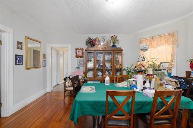 9 Sackett St, Providence, RI 02907 - dining room featuring wood finished floors, a textured ceiling, and baseboards