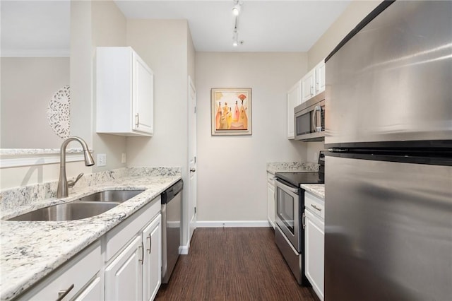 1000 Providence Pl Unit 142, Providence, RI 02903 - kitchen with appliances with stainless steel finishes, a sink, white cabinets, light stone countertops, and baseboards