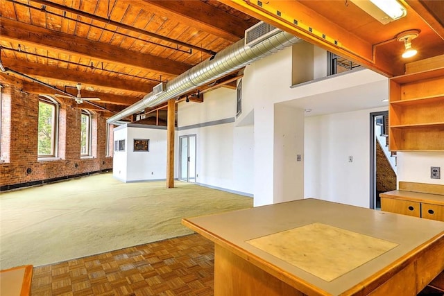 116 Chestnut St Unit G, Providence, RI 02903 - below grade area with wooden ceiling, brick wall, stairs, and carpet flooring