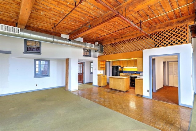116 Chestnut St Unit G, Providence, RI 02903 - kitchen with baseboards, open floor plan, freestanding refrigerator, wood ceiling with exposed beams, and light countertops