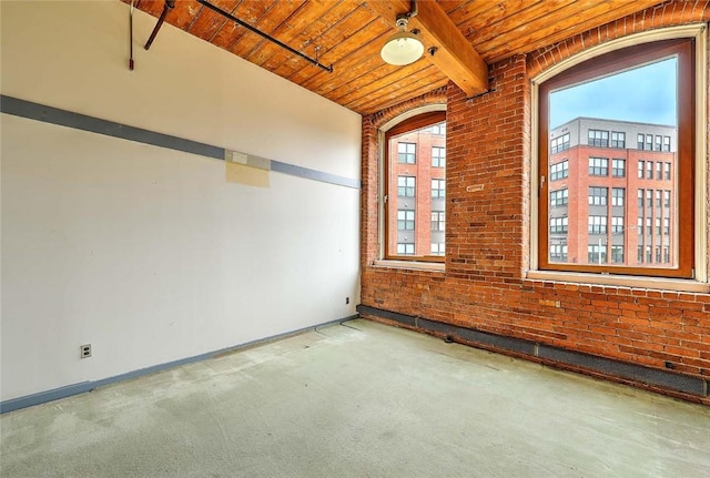 116 Chestnut St Unit G, Providence, RI 02903 - carpeted empty room featuring wood ceiling with exposed beams, baseboards, and brick wall